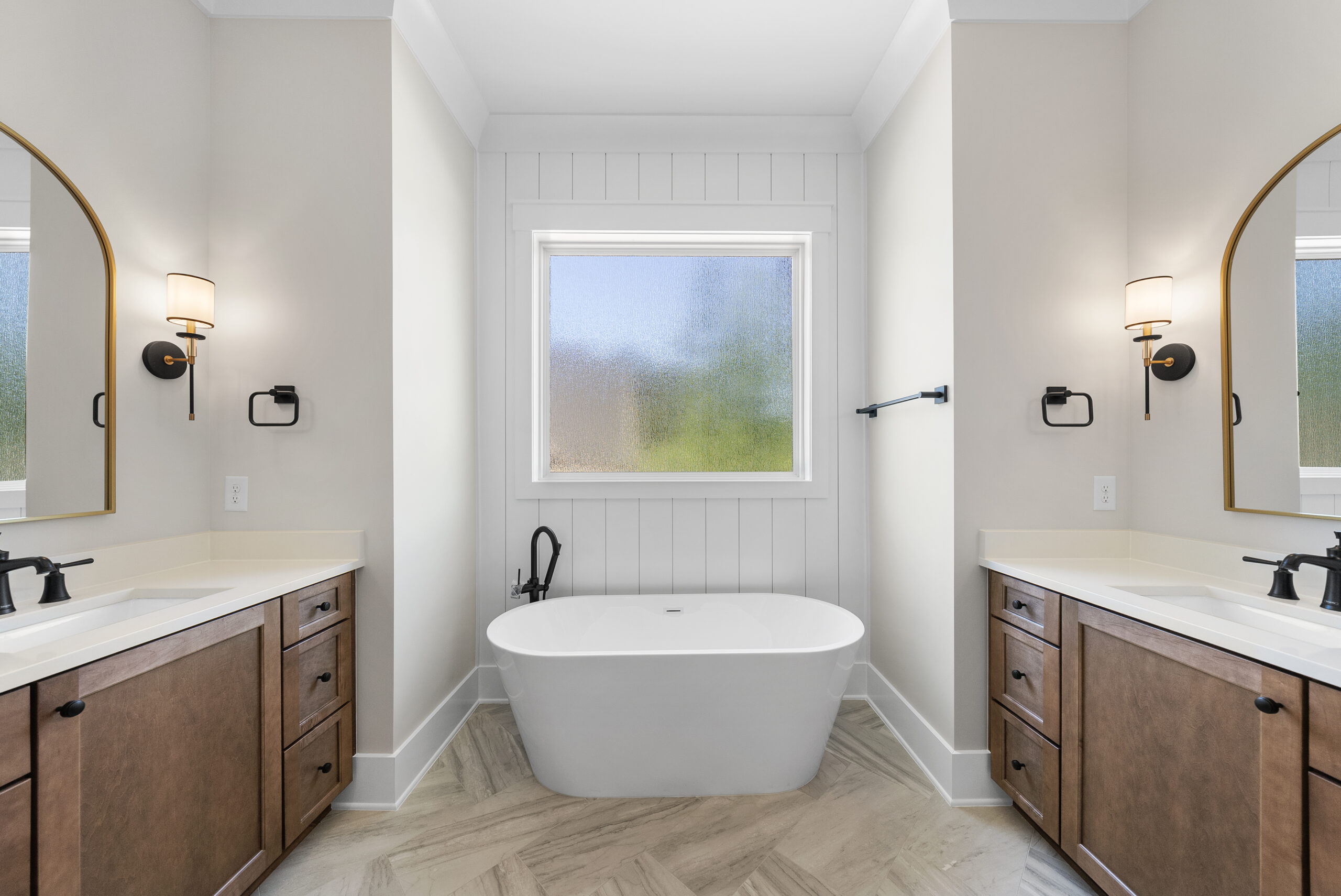Modern powder room design with statement wallpaper and brass fixtures